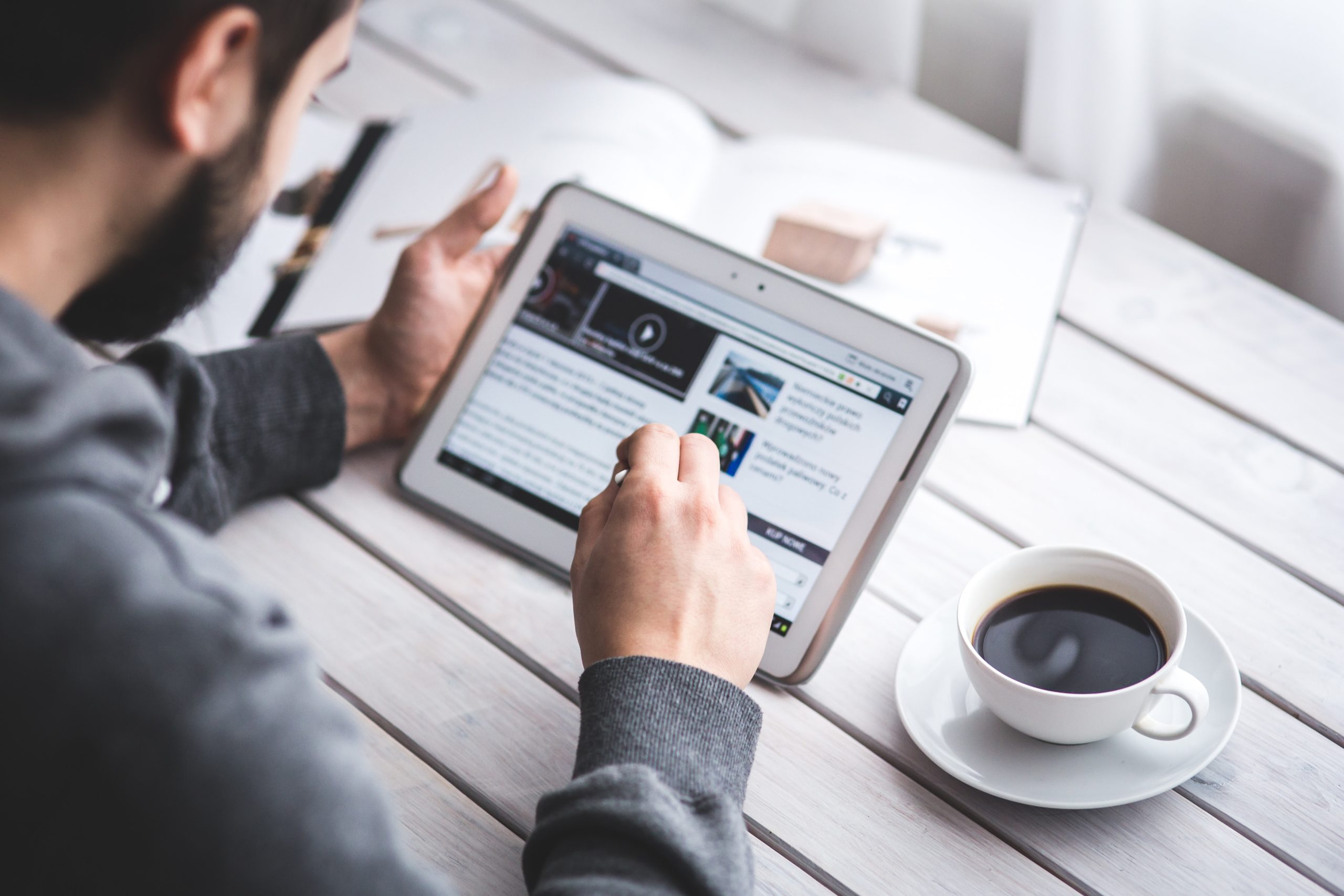 man looking at online news headlines