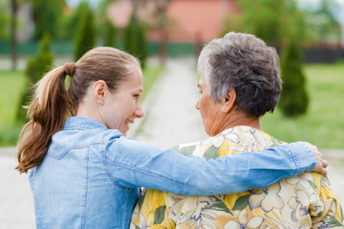 young carer with elderly woman